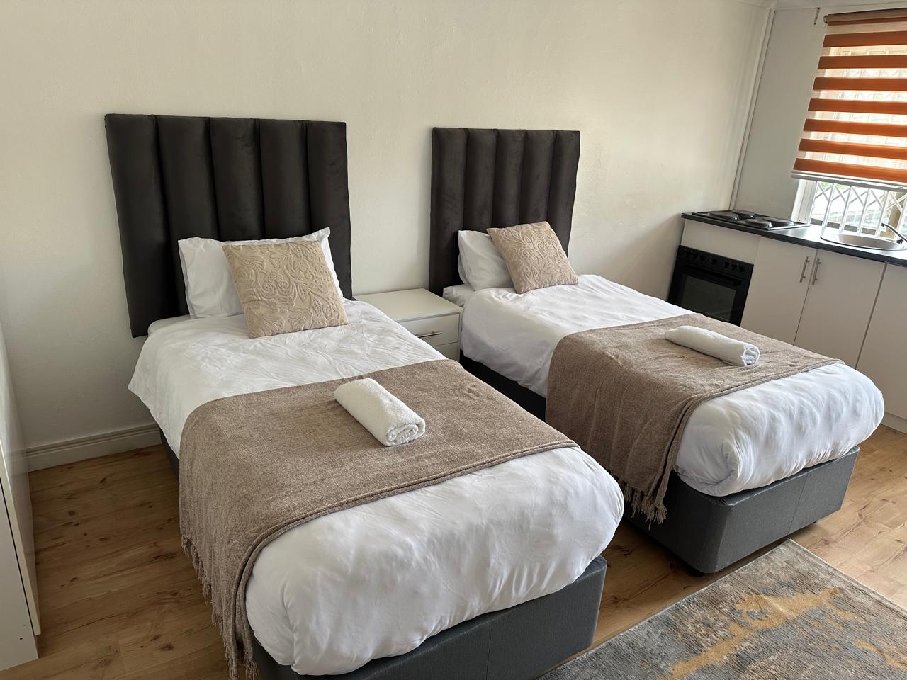 Family room with two single beds and kitchenette
